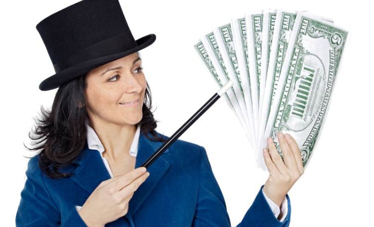 Attractive business woman with a magic wand and hat making appea